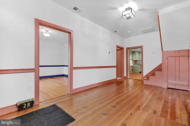 wooden floor in an empty room with a window