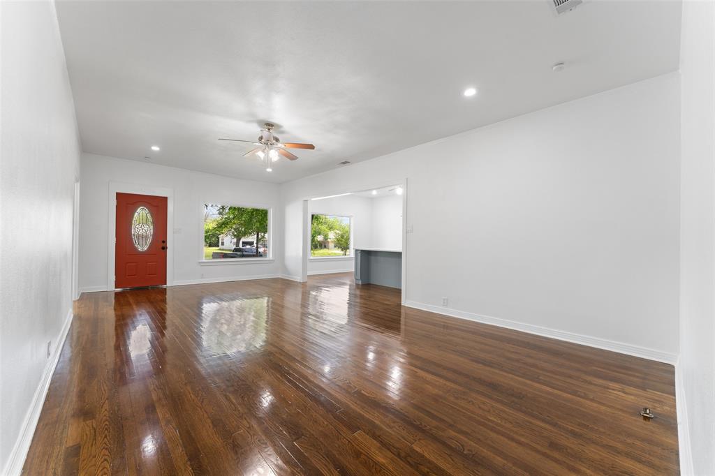 2405 Monroe Street Commerce, TX 75428 - Photo 7 of 31 a view of an empty room with a window and wooden floor