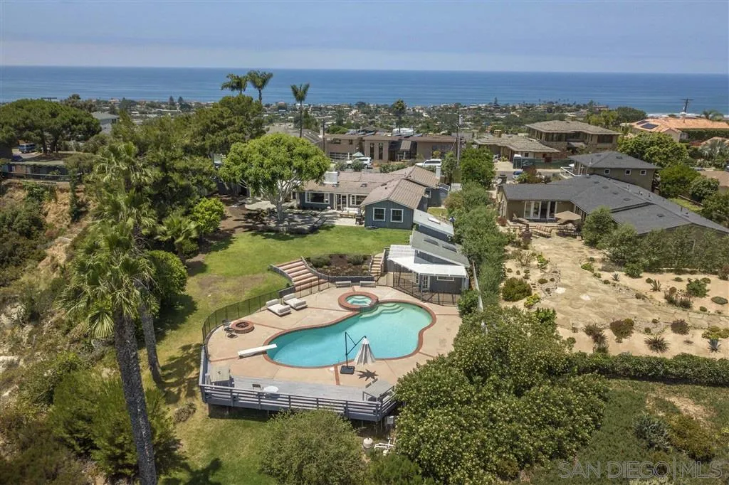 an aerial view of a house with a lake view