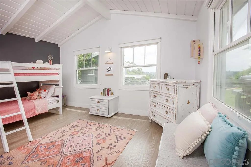 448 Marview Drive Solana Beach, CA 92075 - Photo 16 of 25 a spacious bedroom with a bed and a window