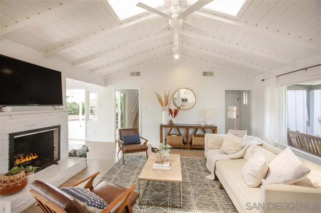 448 Marview Drive Solana Beach, CA 92075 - Photo 9 of 25 a living room with furniture a fireplace and a flat screen tv