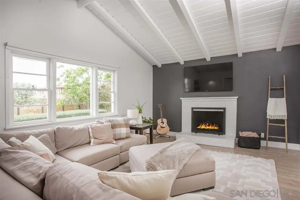 448 Marview Drive Solana Beach, CA 92075 - Photo 10 of 25 a living room with furniture a fireplace and a flat screen tv