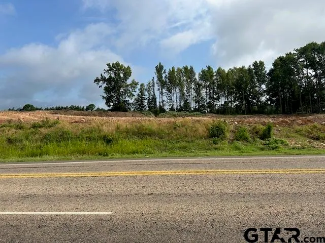 an aerial view of residential house with outdoor space and trees all around