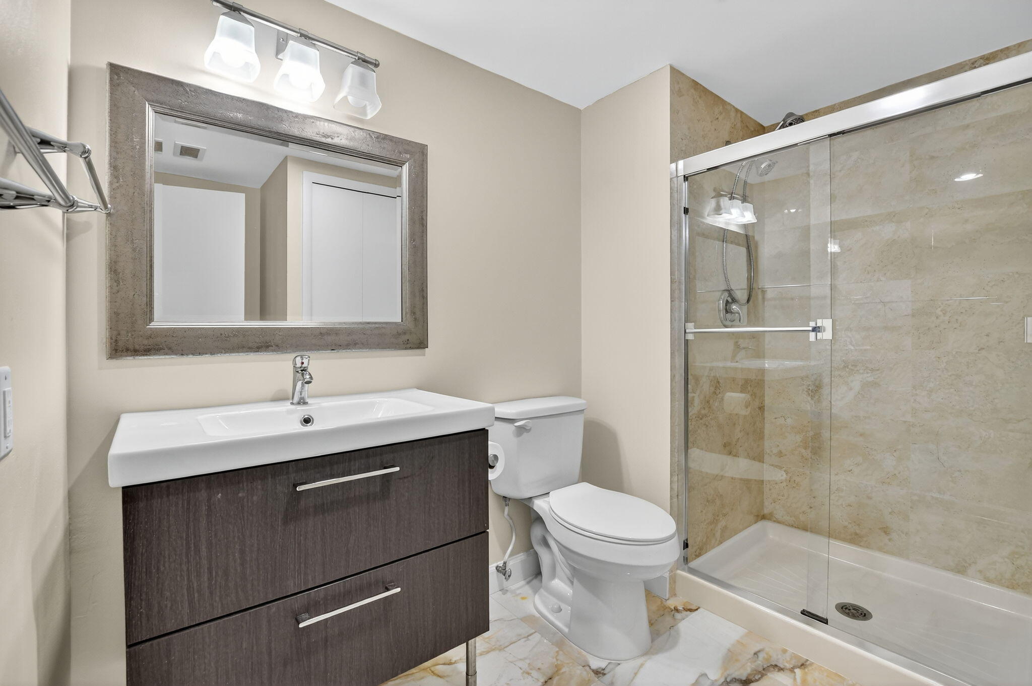 9268 Vista Del Lago, Unit 26D Boca Raton, FL 33428 - Photo 22 of 34 a bathroom with a toilet a sink and shower