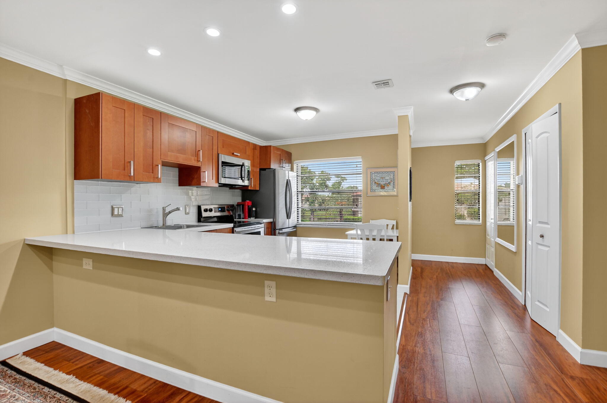 9268 Vista Del Lago, Unit 26D Boca Raton, FL 33428 - Photo 4 of 34 a view of kitchen with sink and wooden floor
