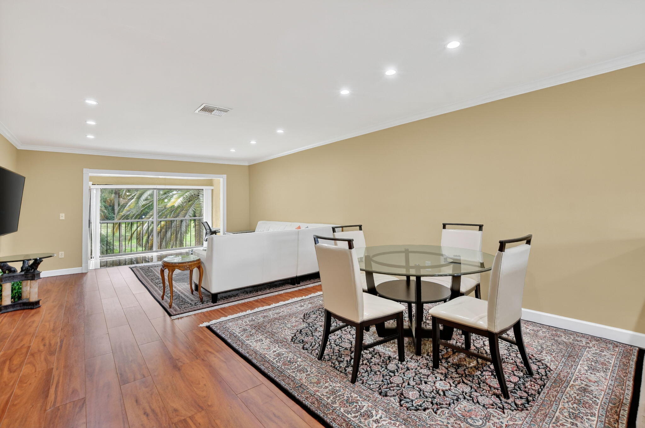 9268 Vista Del Lago, Unit 26D Boca Raton, FL 33428 - Photo 9 of 34 a living room with furniture and a flat screen tv