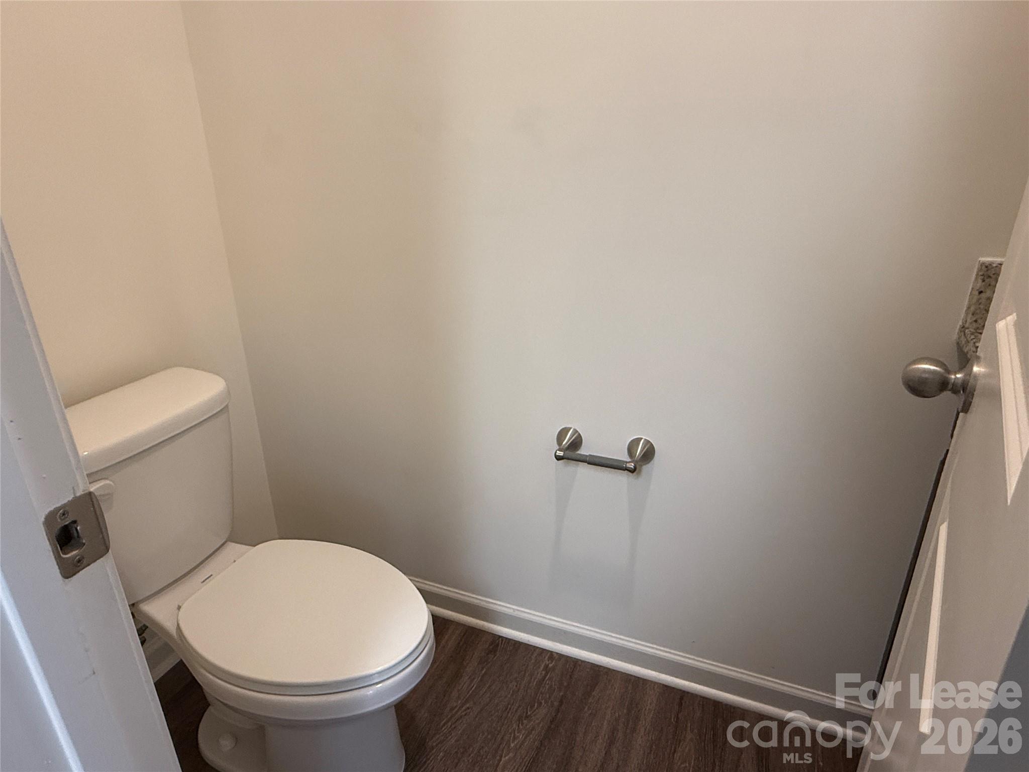 2021 Oakdale Road, Unit K Charlotte, NC 28216 - Photo 12 of 13 a white toilet sitting next to a shower