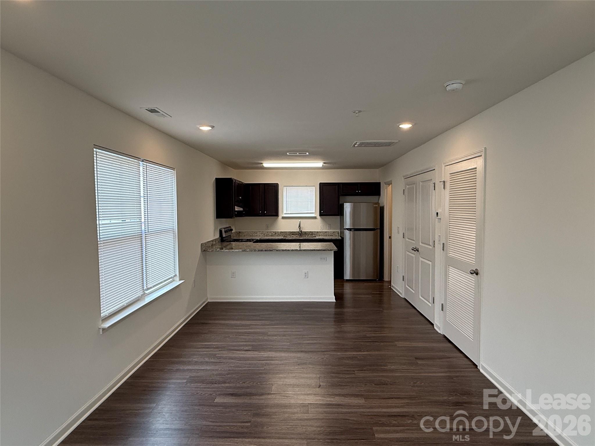 2021 Oakdale Road, Unit K Charlotte, NC 28216 - Photo 3 of 13 a view of kitchen with wooden floor and electronic appliances