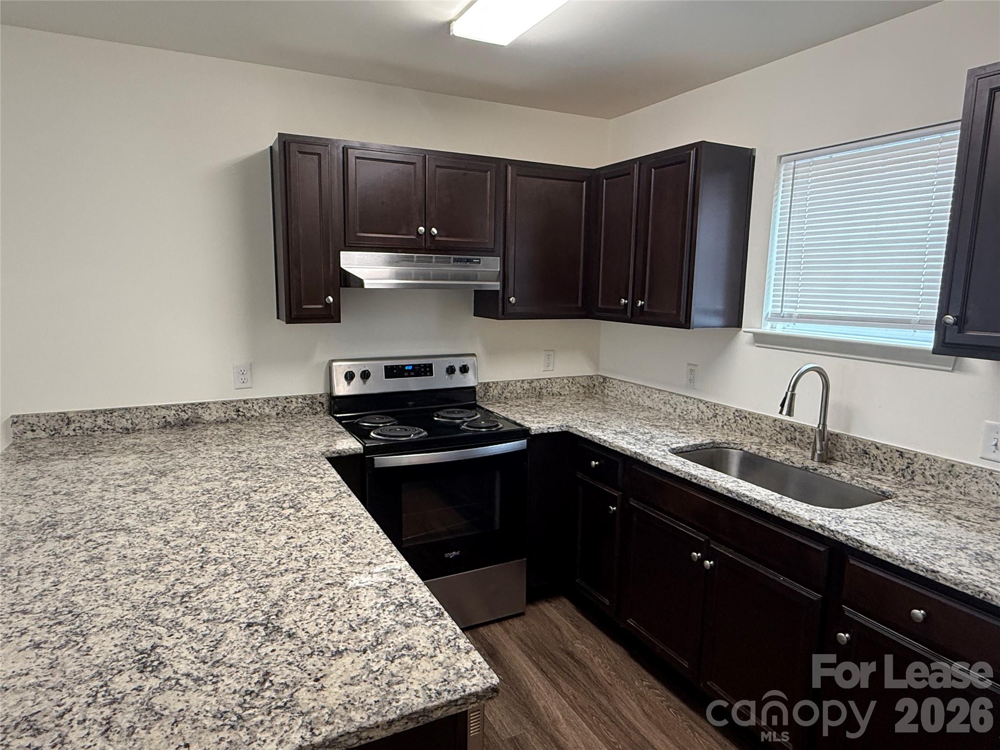 2021 Oakdale Road, Unit K Charlotte, NC 28216 - Photo 4 of 13 a kitchen with stainless steel appliances granite countertop a sink stove and refrigerator