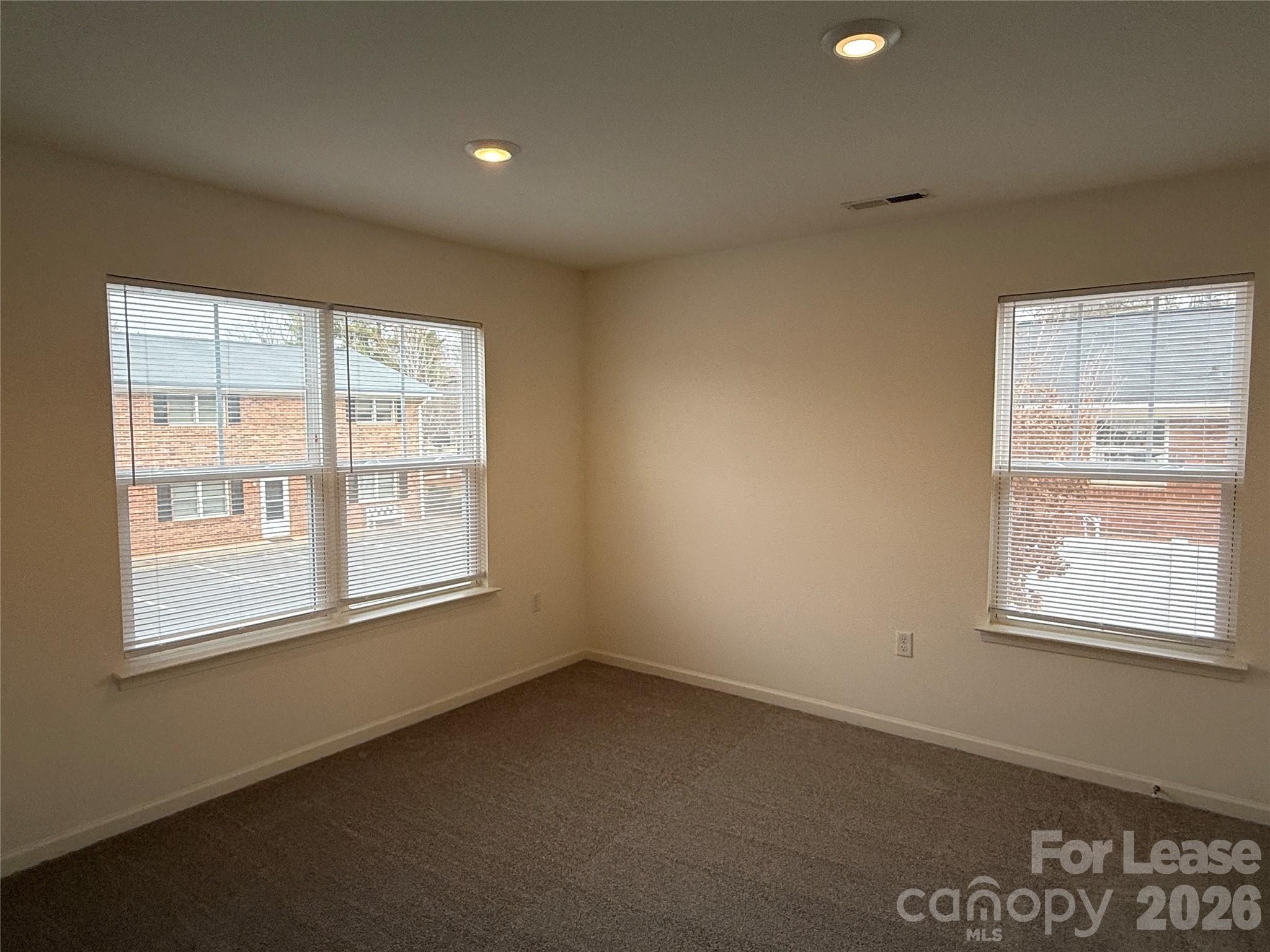 2021 Oakdale Road, Unit K Charlotte, NC 28216 - Photo 6 of 13 an empty room with a window