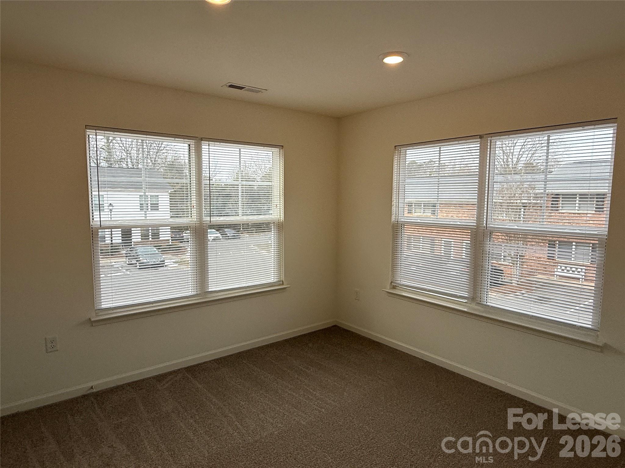 2021 Oakdale Road, Unit K Charlotte, NC 28216 - Photo 8 of 13 an empty room with a window