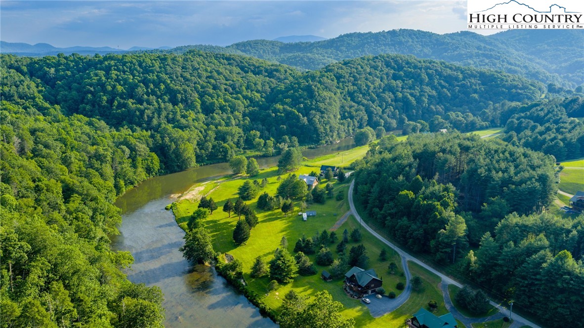 16 Bill Cooper Road Extension Crumpler, NC 28617 - Photo 15 of 21 a view of a garden with a building in the background