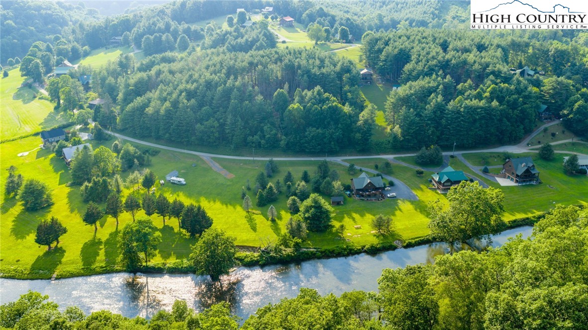 16 Bill Cooper Road Extension Crumpler, NC 28617 - Photo 8 of 21 a view of a lake with a yard