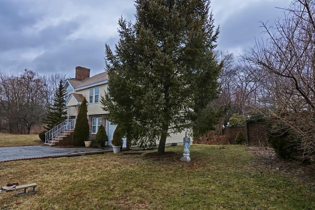 107 Grover Road Medford, MA 02155 - Photo 5 of 42 a front view of a house with a yard