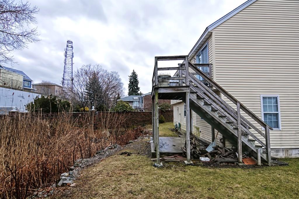 107 Grover Road Medford, MA 02155 - Photo 8 of 42 a view of a house with a yard and wooden fence