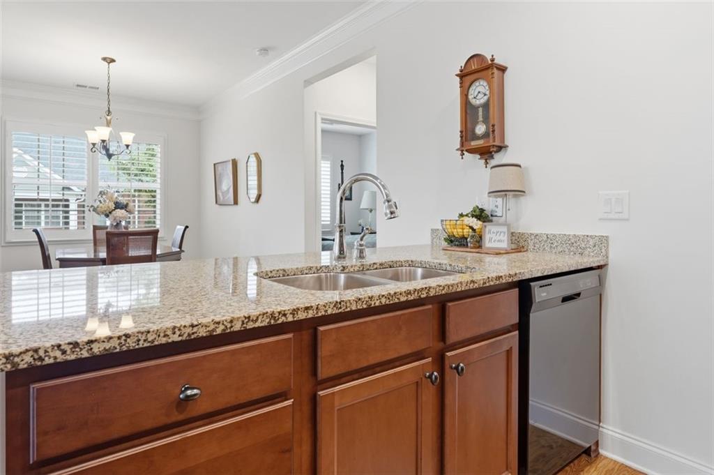 3328 Ivy Ridge Court Buford, GA 30519 - Photo 17 of 34 a kitchen with granite countertop a sink cabinets and wooden floor