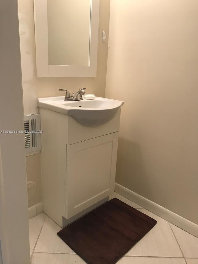 165 Riviera Circle, Unit 589 Weston, FL 33326 - Photo 13 of 15 a bathroom with a sink a toilet and a mirror