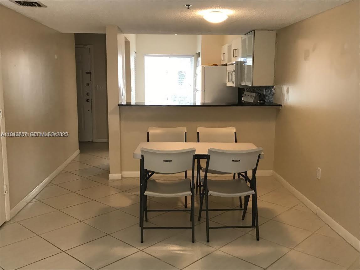 165 Riviera Circle, Unit 589 Weston, FL 33326 - Photo 15 of 15 a kitchen with a sink cabinets and window