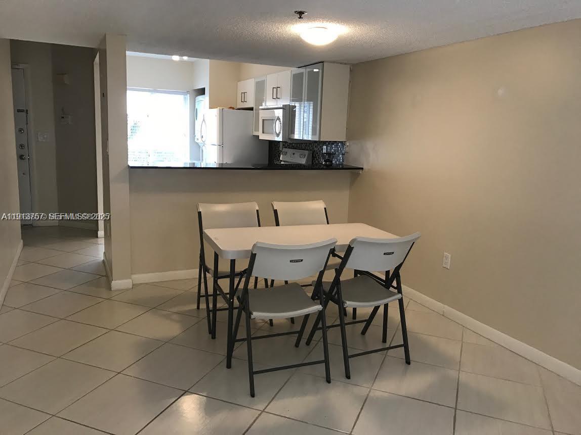 165 Riviera Circle, Unit 589 Weston, FL 33326 - Photo 8 of 15 a view of a dining room with furniture