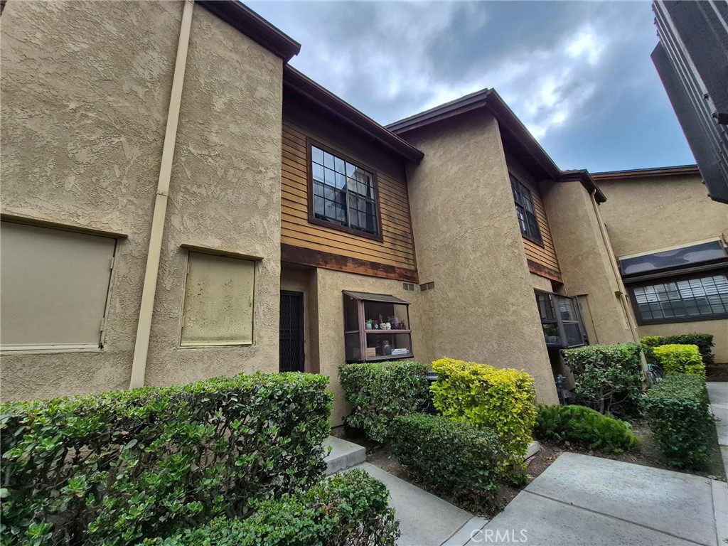 4140 Workman Mill Road, Unit 115 Whittier, CA 90601 - Photo 1 of 14 a front view of a house with garden
