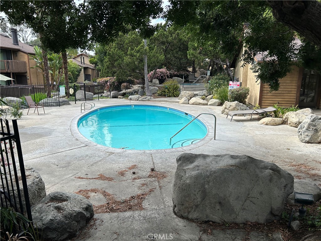 4140 Workman Mill Road, Unit 115 Whittier, CA 90601 - Photo 11 of 14 a swimming pool with outdoor seating and yard