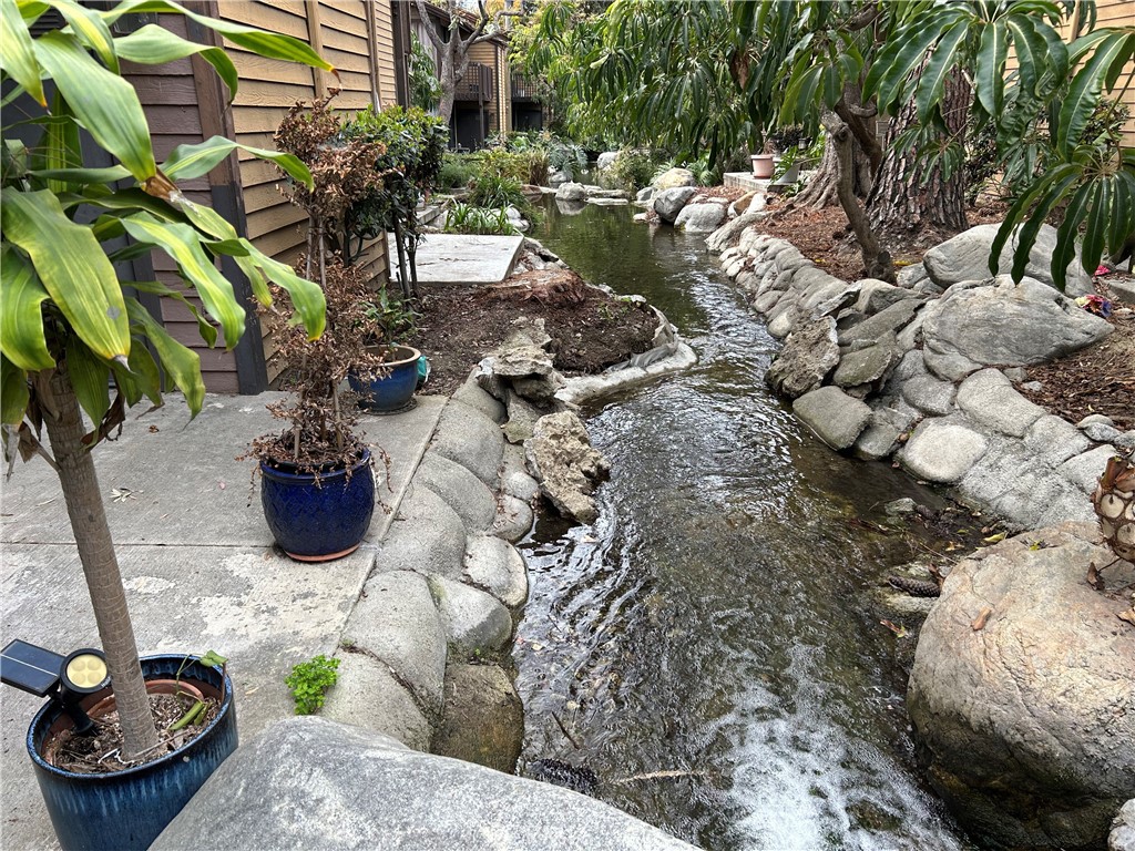 4140 Workman Mill Road, Unit 115 Whittier, CA 90601 - Photo 2 of 14 a view of a garden with plants and a fountain