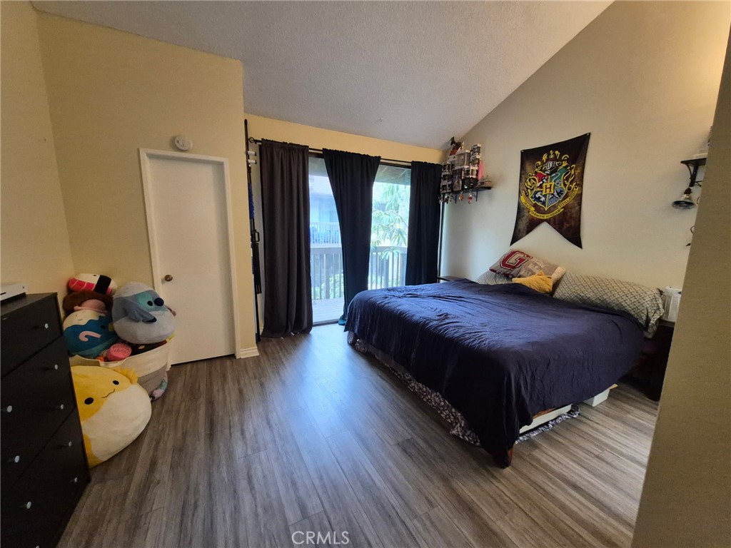 4140 Workman Mill Road, Unit 115 Whittier, CA 90601 - Photo 4 of 14 a bedroom with a bed and wooden floor