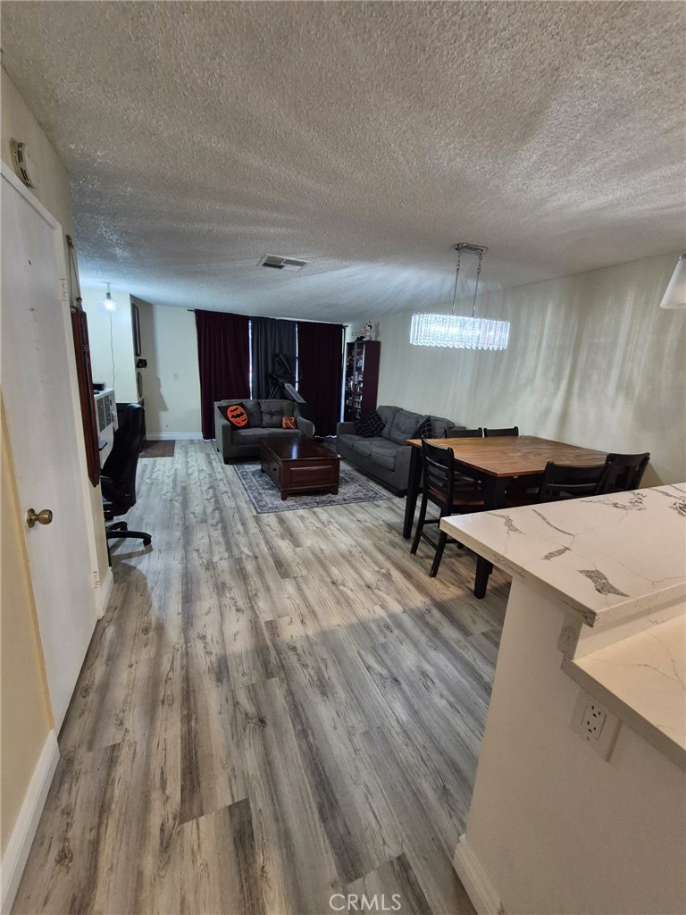 4140 Workman Mill Road, Unit 115 Whittier, CA 90601 - Photo 6 of 14 a living room with furniture and a wooden floor