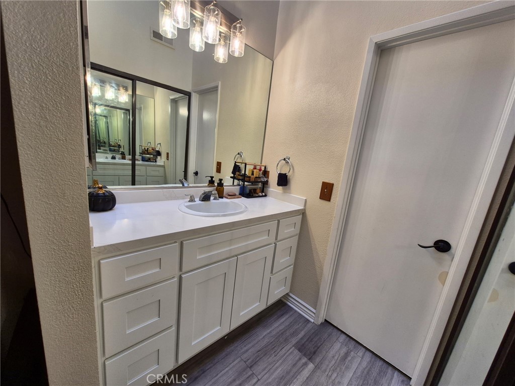 4140 Workman Mill Road, Unit 115 Whittier, CA 90601 - Photo 10 of 14 a bathroom with a double vanity sink and mirror