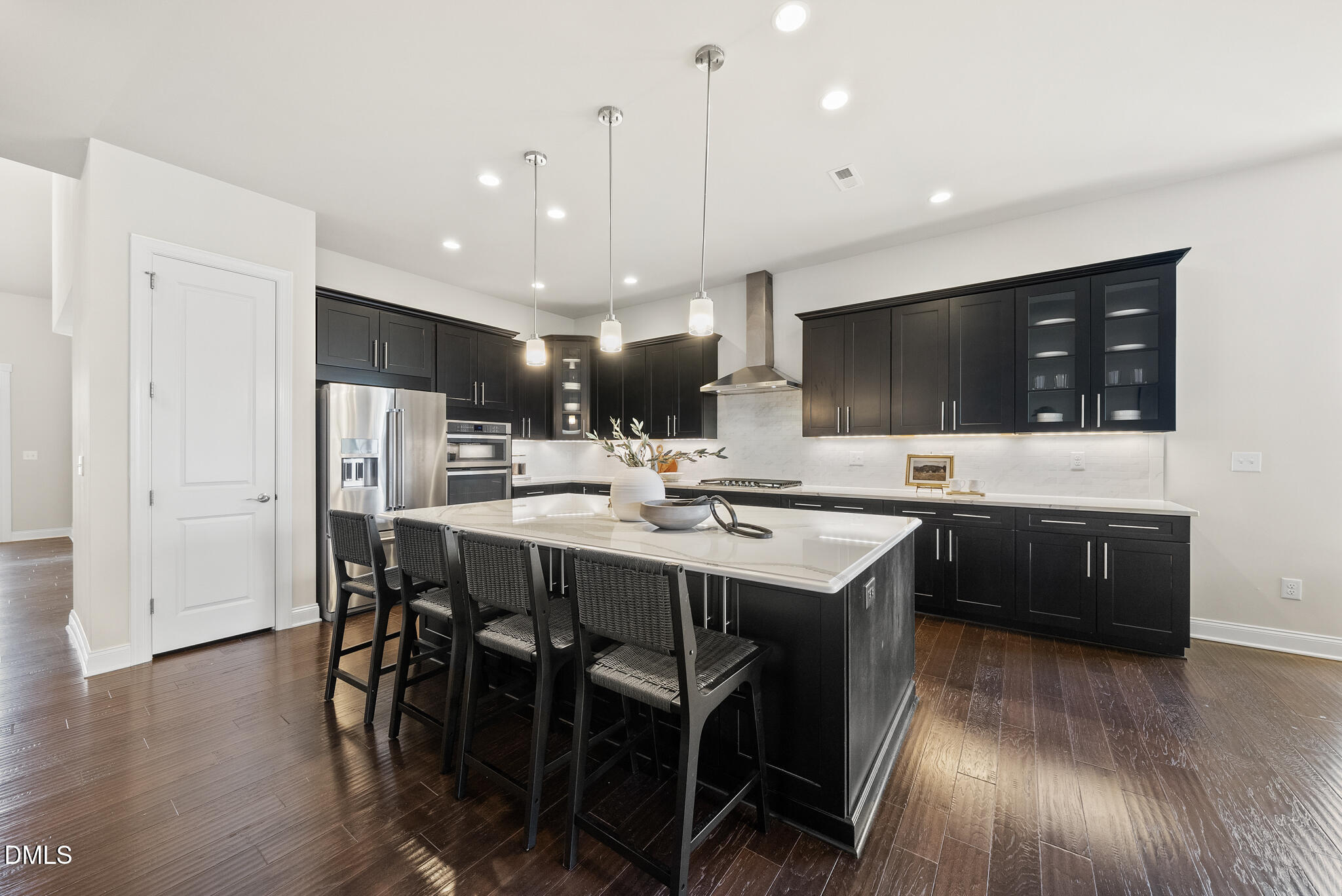 2648 Beckwith Road Apex, NC 27523 - Photo 12 of 59 a kitchen with stainless steel appliances kitchen island granite countertop a sink a stove a dining table and chairs