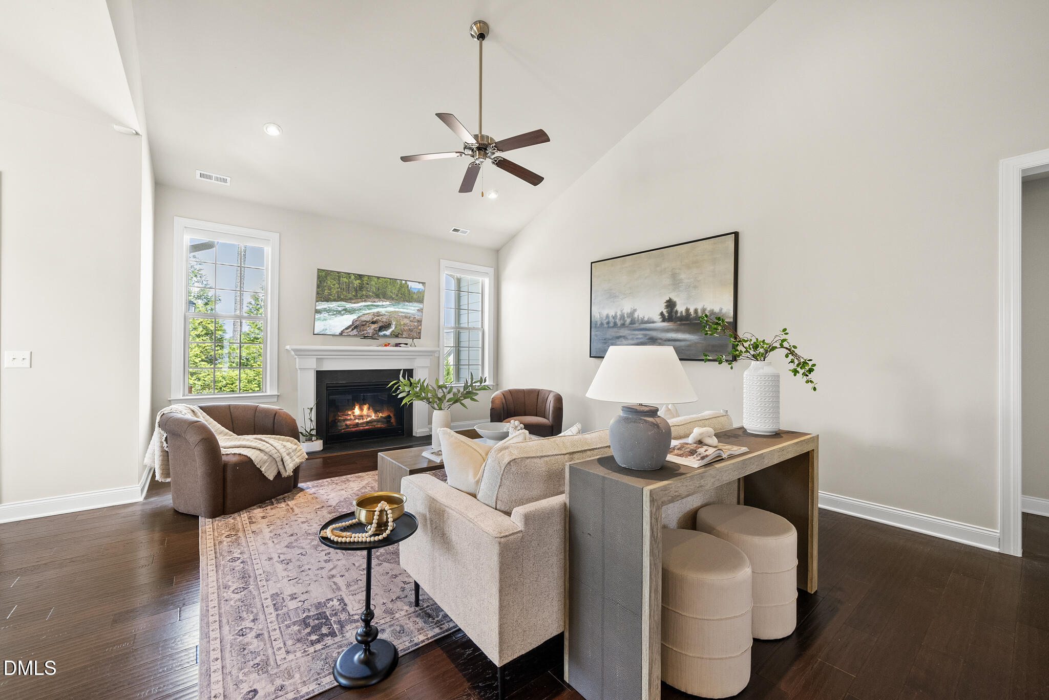2648 Beckwith Road Apex, NC 27523 - Photo 17 of 59 a living room with furniture a fireplace and wooden floor