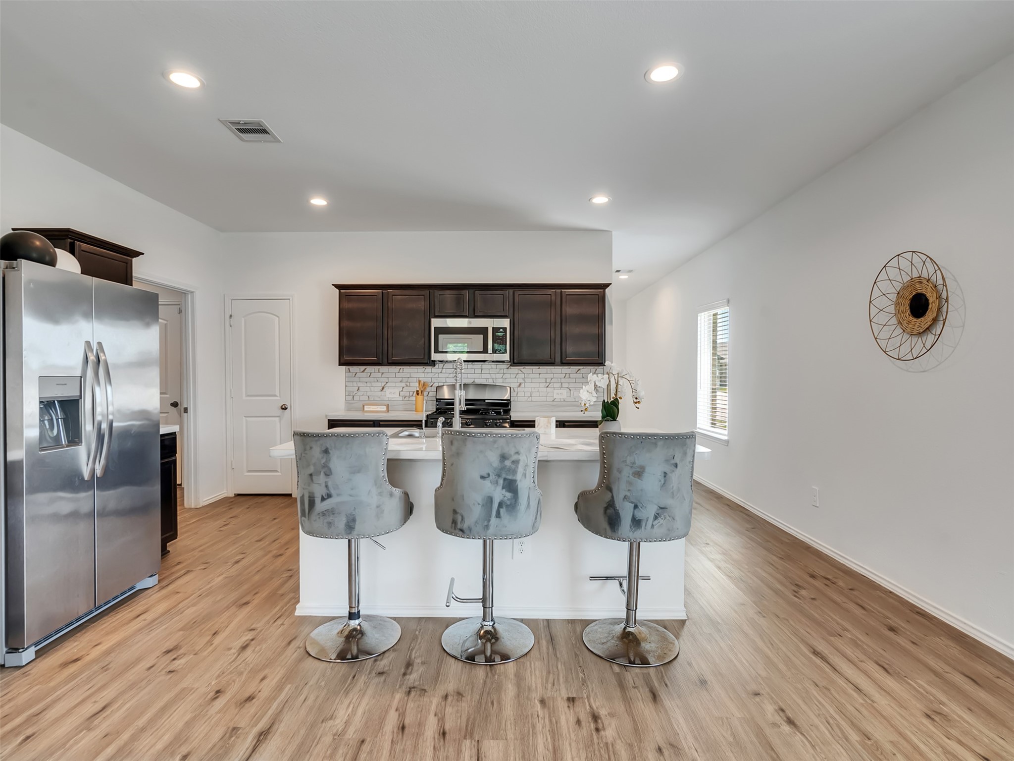 22503 Aspen Tarn Trail Spring, TX 77373 - Photo 12 of 30 a view of a kitchen with dining space and wooden floor