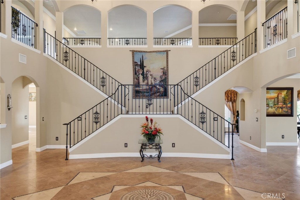 6959 Wyndham Hill Drive Riverside, CA 92506 - Photo 16 of 75 a view of staircase with lots of frames on wall and windows
