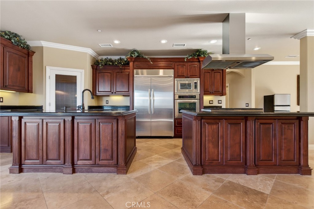 6959 Wyndham Hill Drive Riverside, CA 92506 - Photo 22 of 75 a kitchen with refrigerator and cabinets