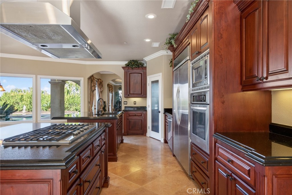 6959 Wyndham Hill Drive Riverside, CA 92506 - Photo 23 of 75 a kitchen with stainless steel appliances granite countertop a stove a refrigerator and a sink