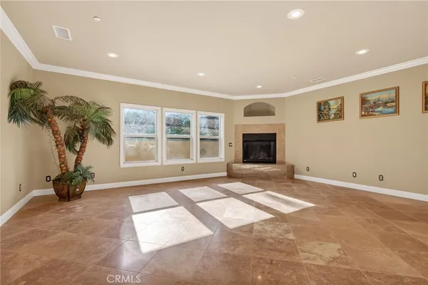 a spacious bedroom with a bed couches and a fireplace