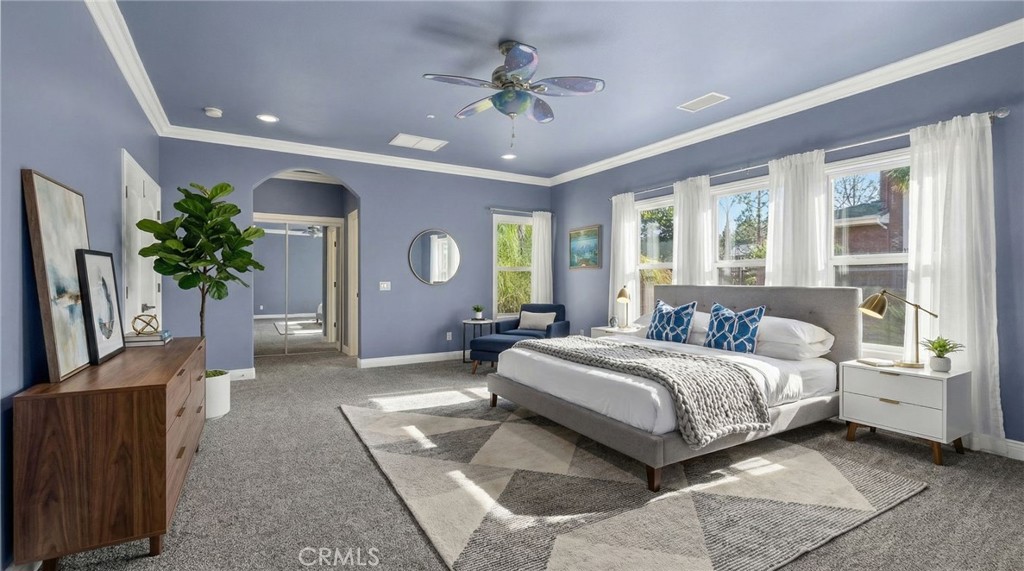 6959 Wyndham Hill Drive Riverside, CA 92506 - Photo 37 of 75 a spacious bedroom with a large bed and a chandelier