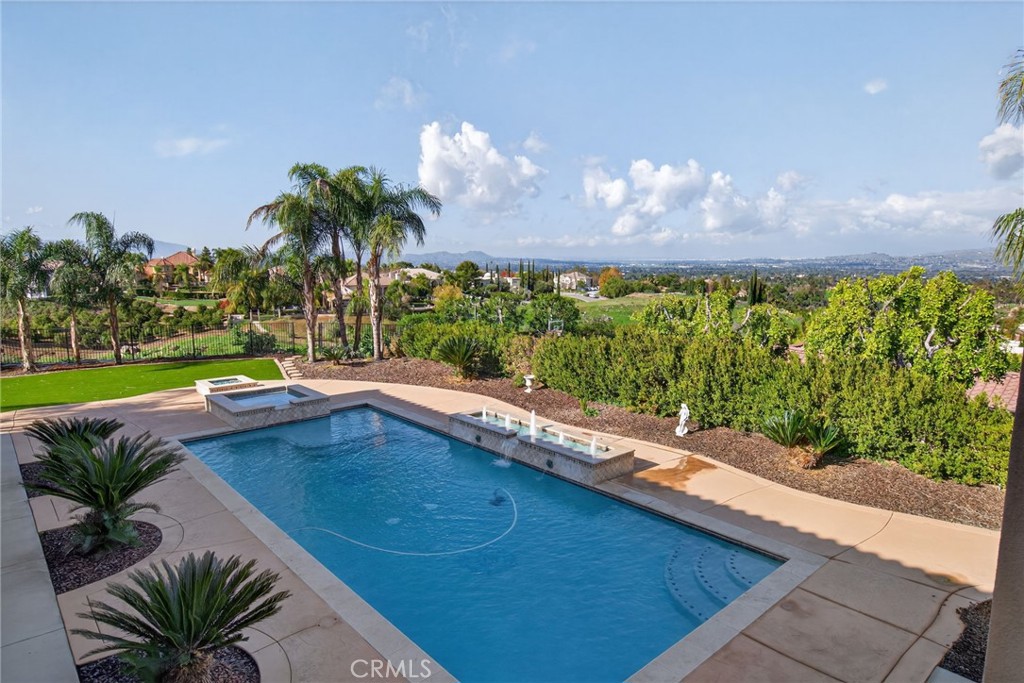 6959 Wyndham Hill Drive Riverside, CA 92506 - Photo 60 of 75 a view of a swimming pool with a yard and a fountain