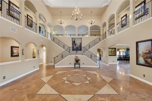 a view of staircase with lots of frames on wall and windows