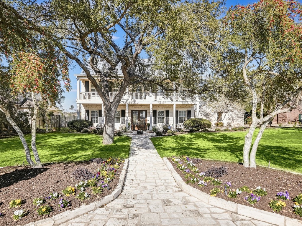 8908 Bell Mountain Drive Austin, TX 78730 - Photo 1 of 1 a front view of a house with yard and green space