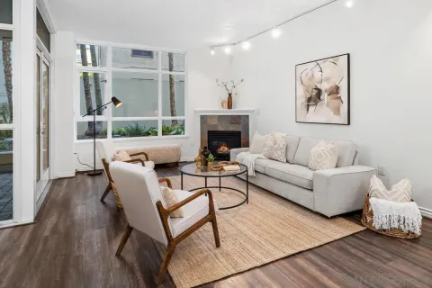 a living room with furniture a fireplace and a table
