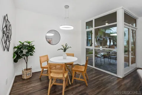 a dining room with furniture and wooden floor