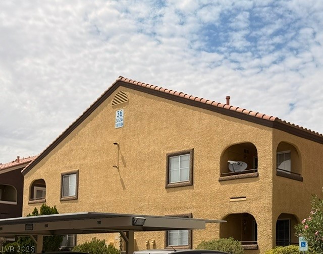 7950 West Flamingo Road, Unit 2142 Las Vegas, NV 89147 - Photo 2 of 3 A classic stucco building with terracotta roof tiles offers appealing curb appeal.