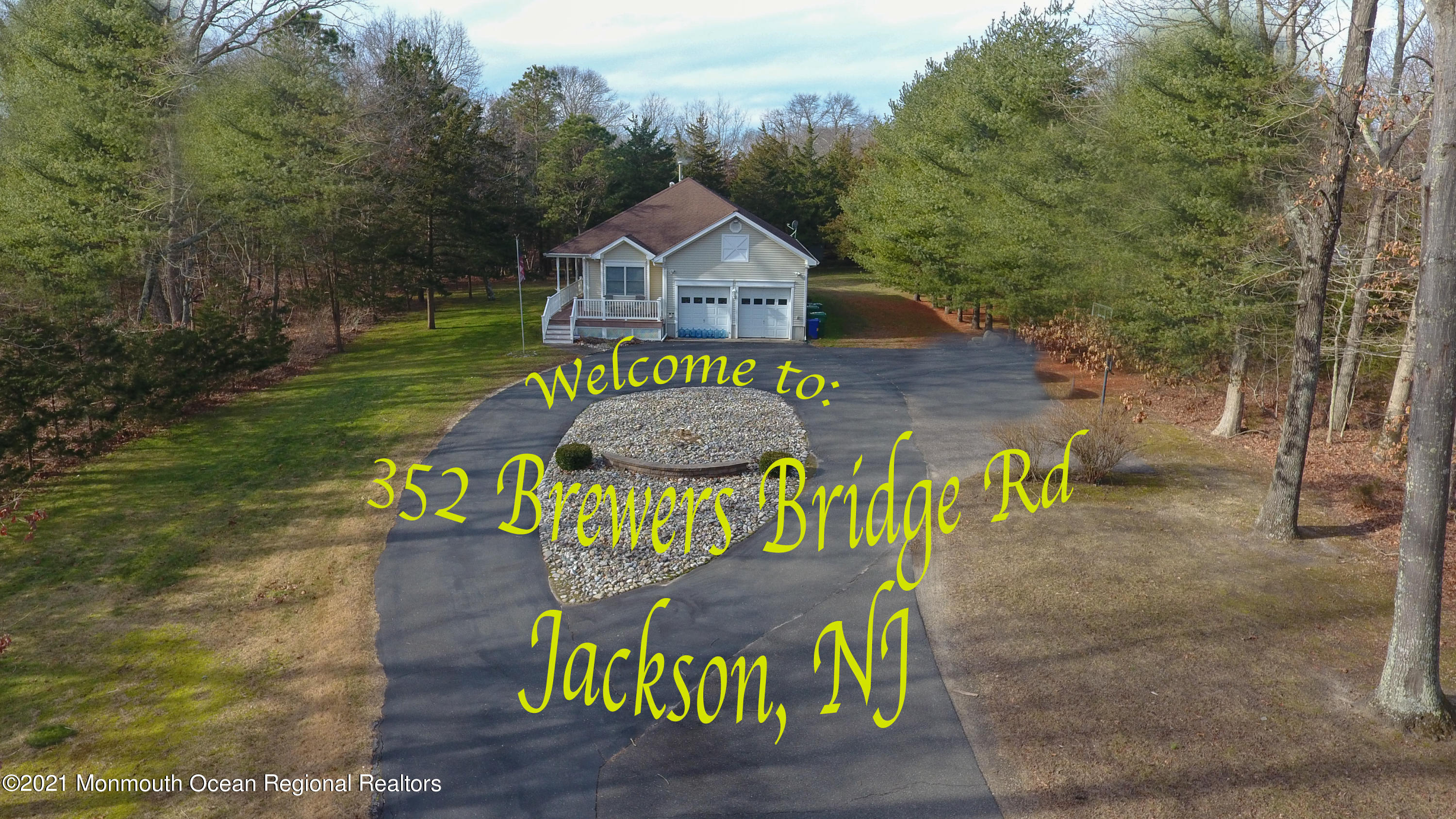352 Brewers Bridge Road Jackson, NJ 08527 - Photo 2 of 34 a sign that is sitting on a wooden deck