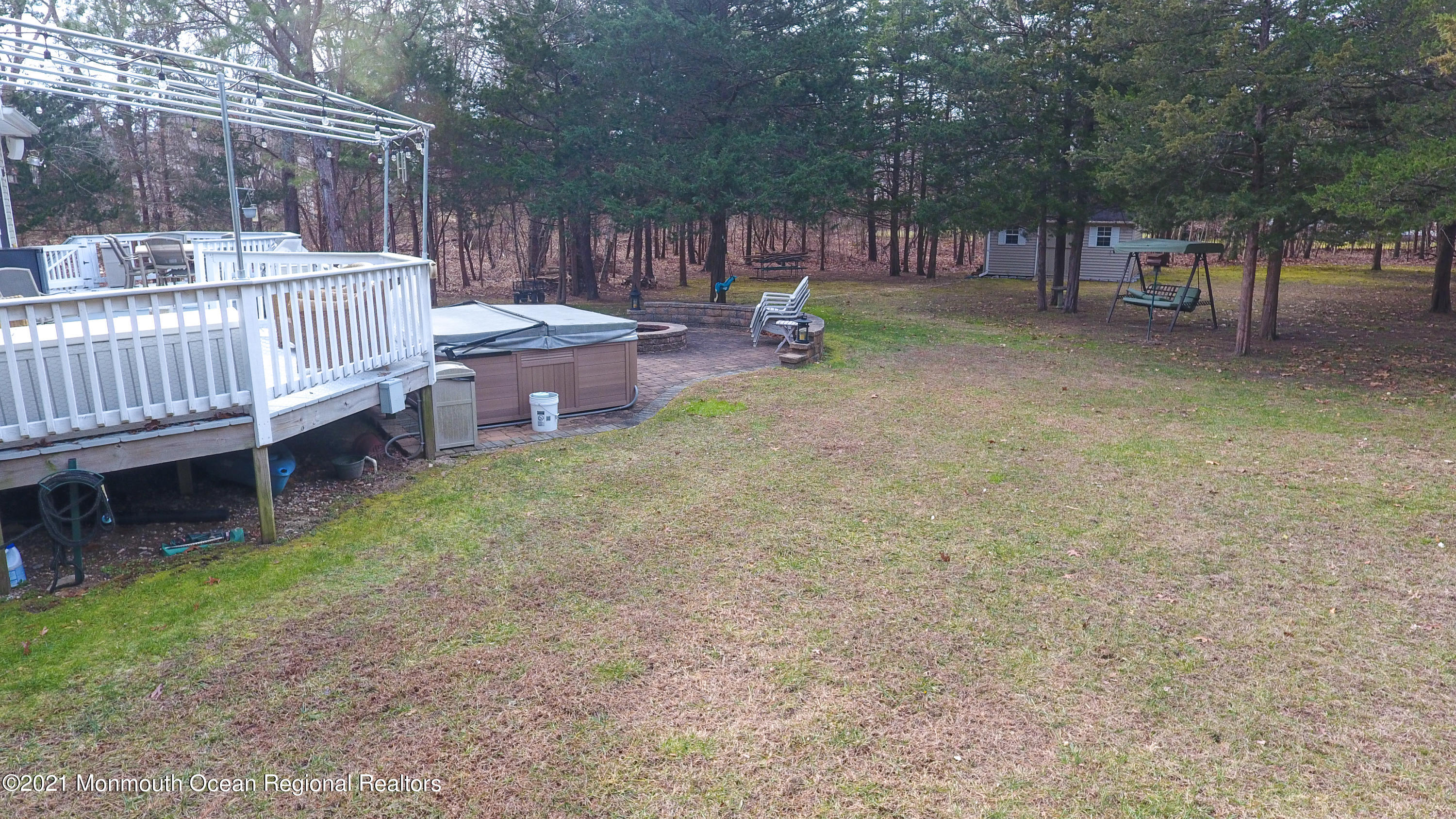 352 Brewers Bridge Road Jackson, NJ 08527 - Photo 11 of 34 a view of a backyard with sitting area and wooden fence