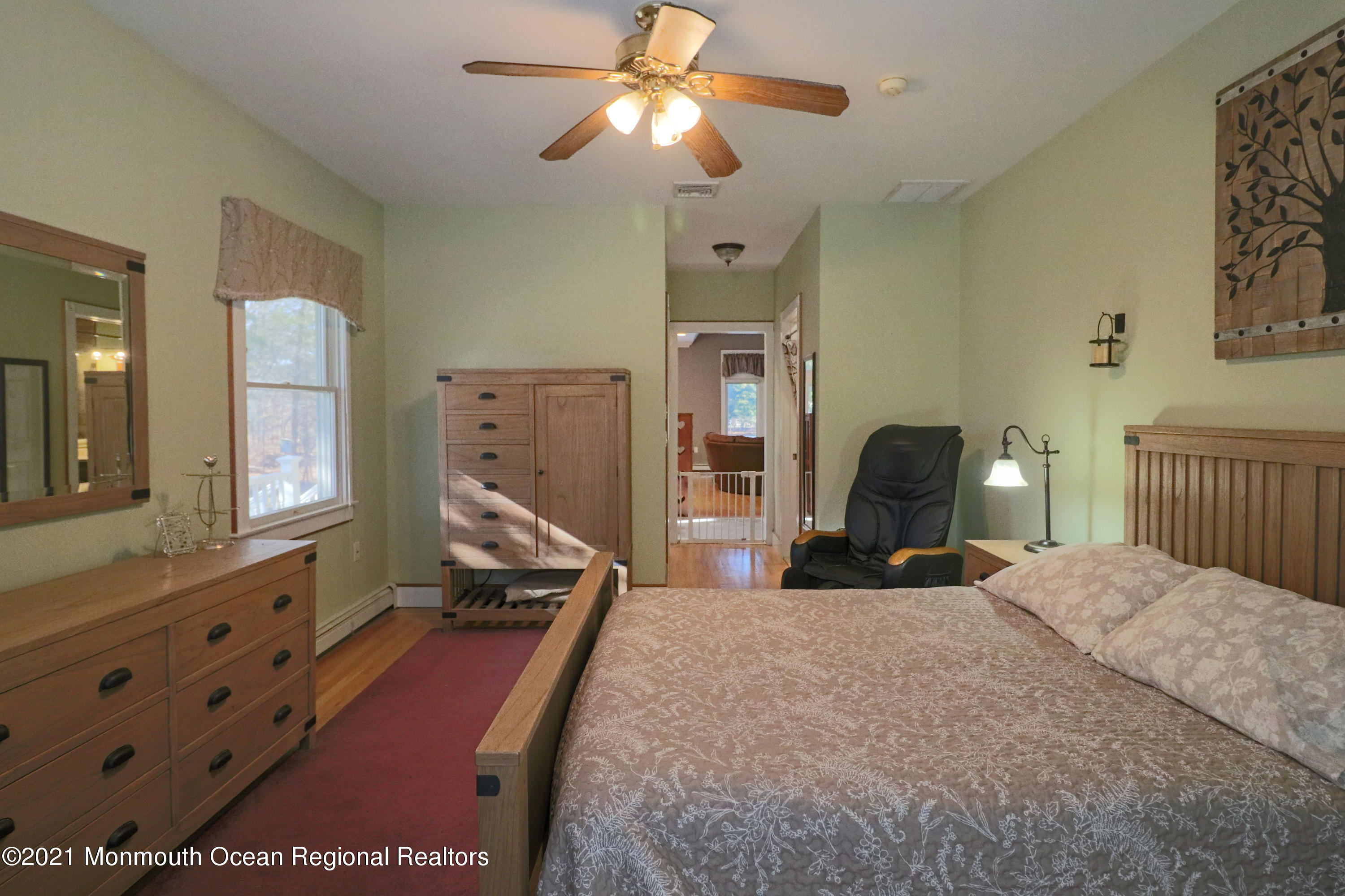352 Brewers Bridge Road Jackson, NJ 08527 - Photo 24 of 34 a bedroom with a bed and a chandelier