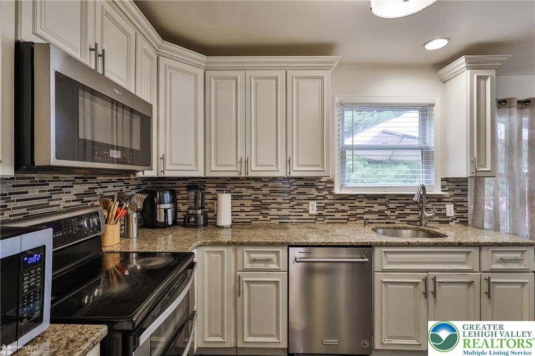 204 Ridings Circle Macungie, PA 18062 - Photo 13 of 53 a kitchen with stainless steel appliances granite countertop a stove a sink and a microwave