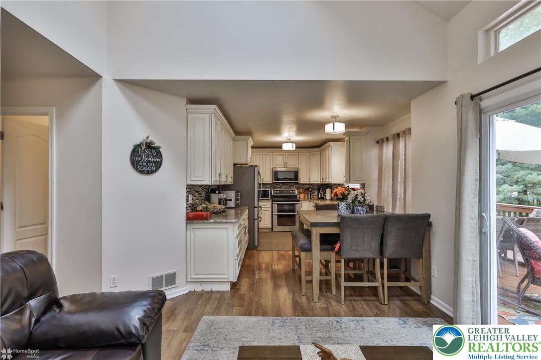 204 Ridings Circle Macungie, PA 18062 - Photo 25 of 53 a living room with stainless steel appliances furniture a rug and a kitchen view