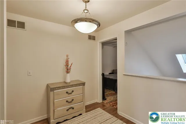 a bedroom with a bed and a television