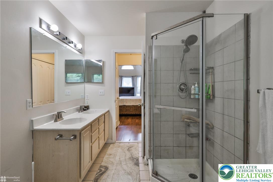 204 Ridings Circle Macungie, PA 18062 - Photo 36 of 53 a bathroom with a shower a sink and mirror